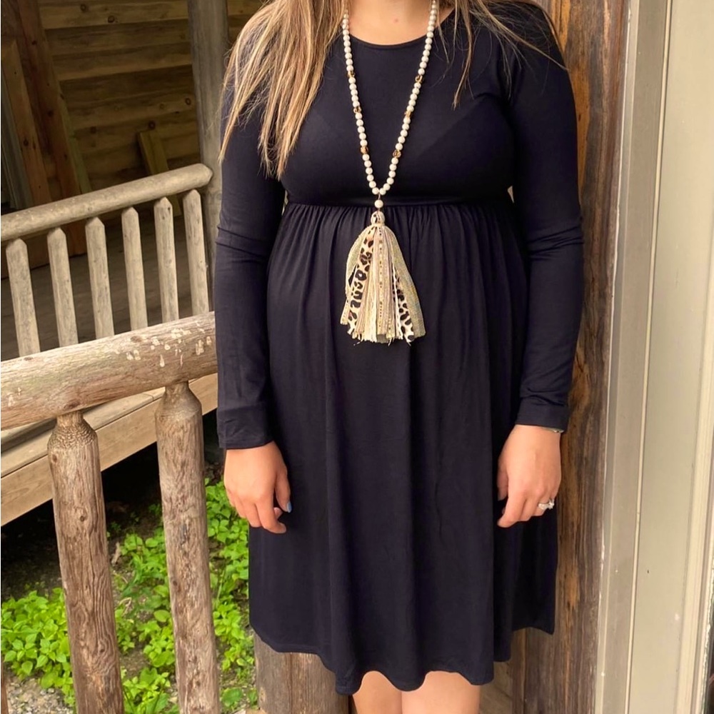 Black long sleeve knee length dress with pockets.